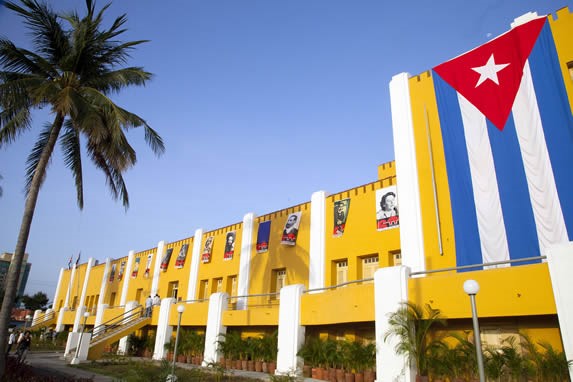 fachada amarilla con bandera cubana colgando