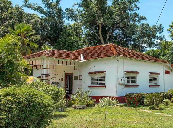 White facade with red tile roof.