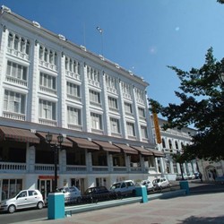 White facade of the hotel under blue sky