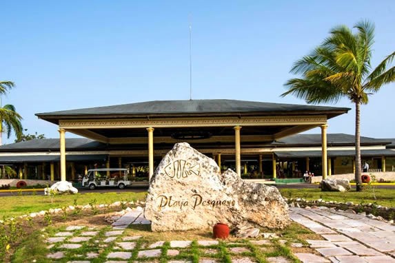 hotel facade with palm trees around