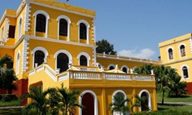 yellow colonial facade under blue sky
