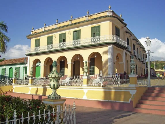 Facade of the Brunet Palace under the blue sky.