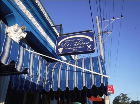 colonial facade with blue awnings