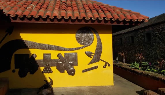 fachada con tejas rojas y decoración en la pared
