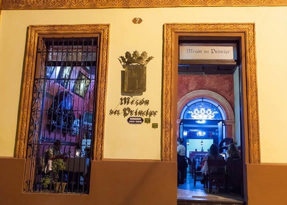 colonial facade with restaurant poster