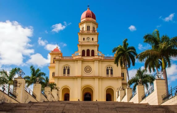 colonial building facade surrounded by palm trees