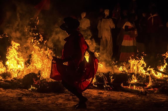 Men dancing around fire.