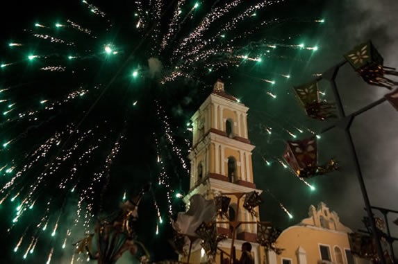 fireworks exploding and church in the background