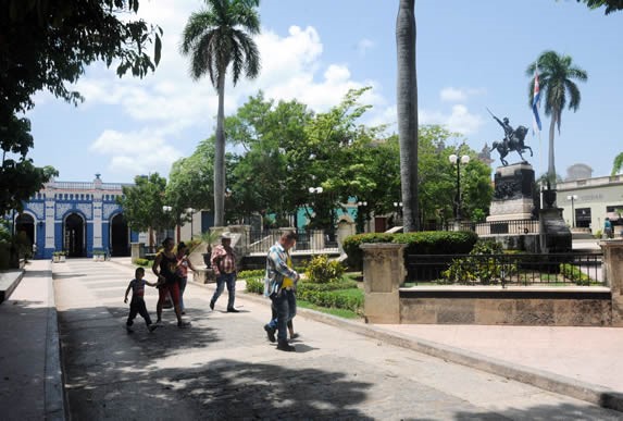 park with greenery and statue in the center