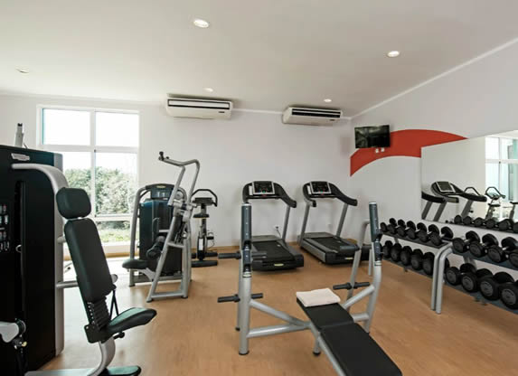 hotel gym with natural light and mirrors