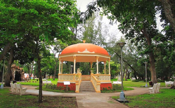 gazebo surrounded by trees and park benches