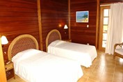 two-bed room with wooden walls