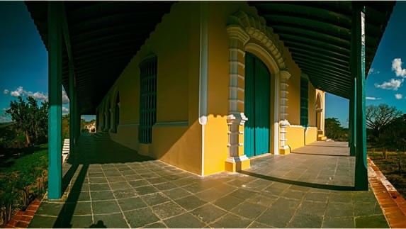 yellow colonial portal with blue columns