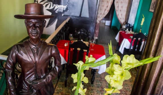 wooden furniture and statue of Benny Moré