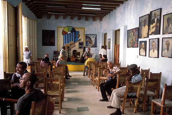 customers in wooden chairs and stage in the back