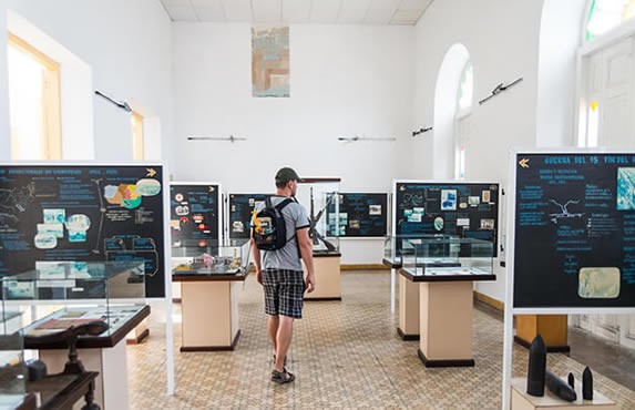 tourist observing objects in museum exhibition