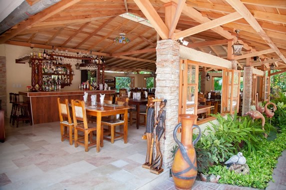 furniture under wooden ceiling and bar in the back