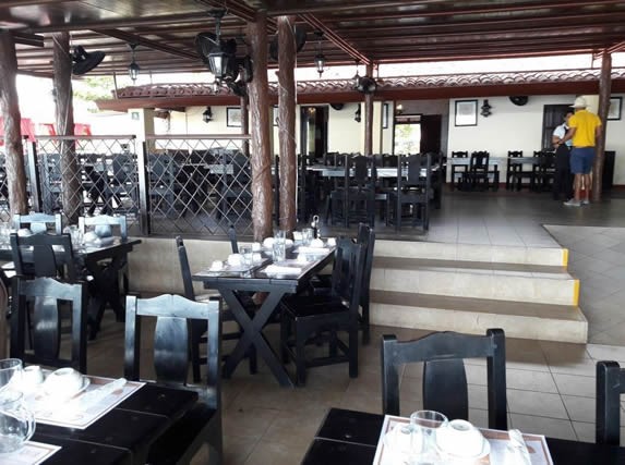 chairs and tables under wooden roof