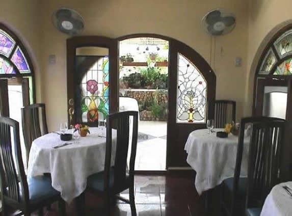 wooden furniture and windows with stained glass.
