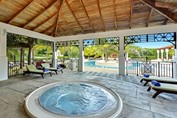 indoor wooden jacuzzi with sun loungers