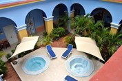 Jacuzzi with sun beds and plants around