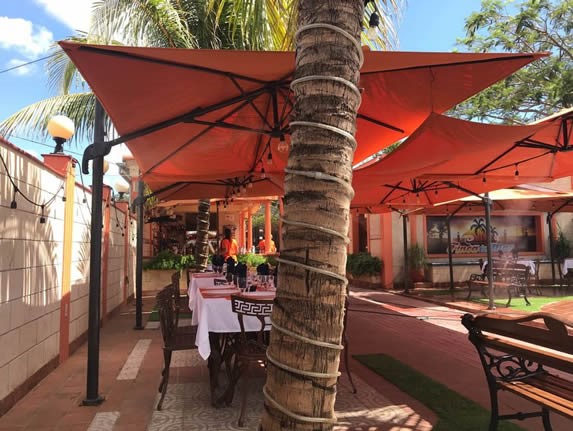 tables under umbrellas in the front yard