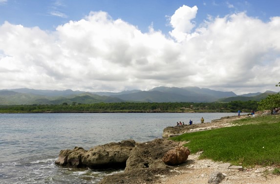 sea ​​surrounded by green and rocky surface