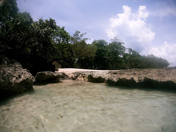 lagoon surrounded by rocks and vegetation