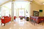 lobby with red furniture and wooden bar