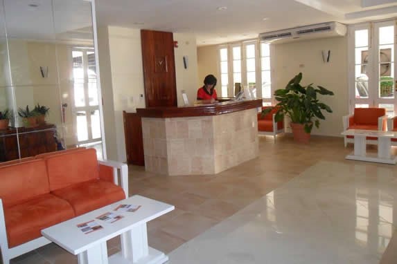 small lobby with wooden furniture and reception