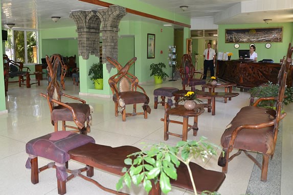 lobby with rustic wooden furniture and plants
