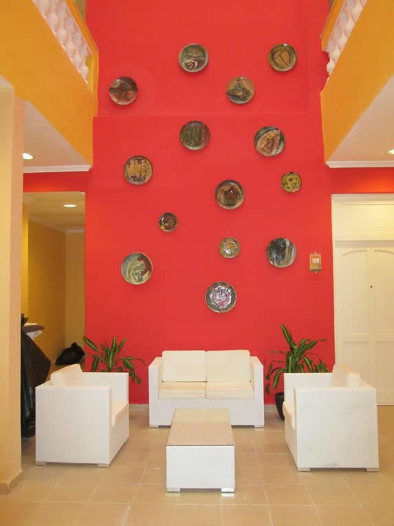 white furniture and red wall decorated with dishes