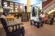 tourists in the lobby with wooden furniture