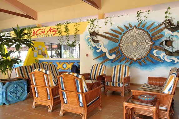 Lobby decorated with colorful mural and furniture