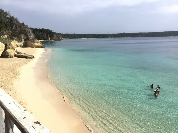 playa con rocas y vegetación alrededor