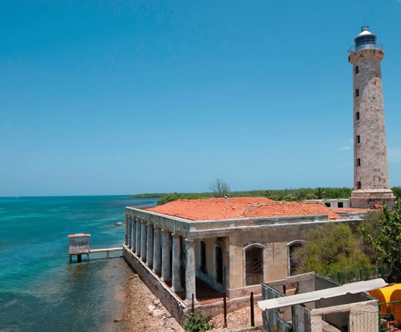 lighthouse on the shore of the blue sea