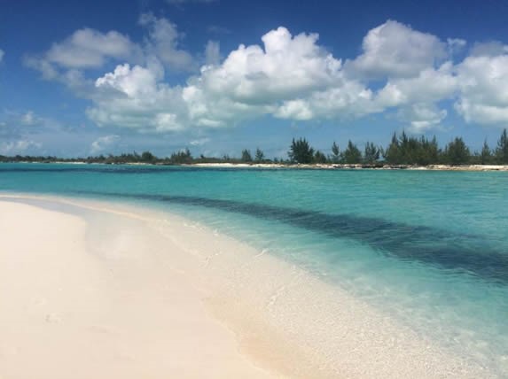 crystal clear water beach and blue sky