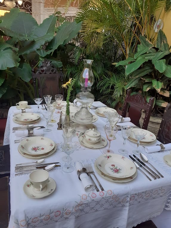 Table with crockery and antique cutlery.