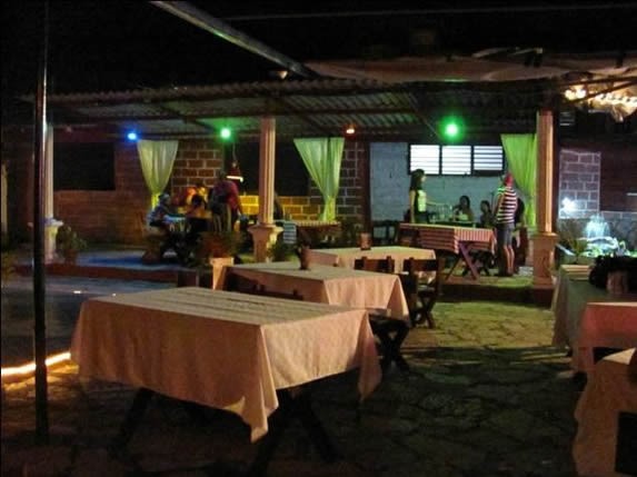 wooden tables under roof surrounded by lights