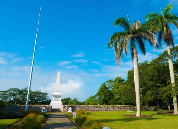 marble monument surrounded by palm trees