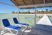 pier on the water with deckchairs under roof