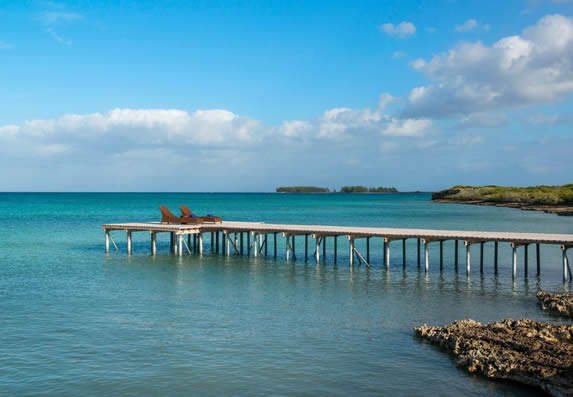 wooden pier on the sea and lounge chairs