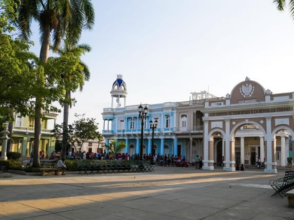 park surrounded by colonial buildings with plants