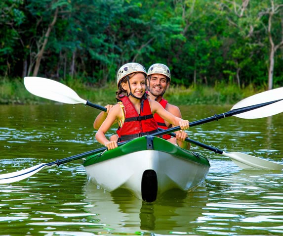 Tourists riding kayak in the park