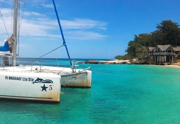 small sailboat near the shore of the beach