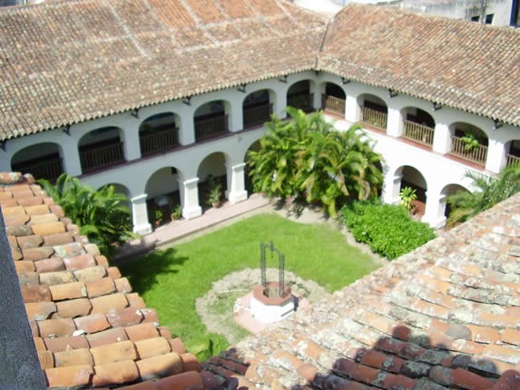 inner courtyard of the church with well and plants