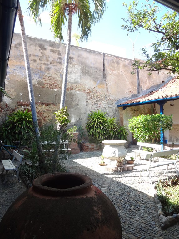 interior courtyard with vegetation and tinajon