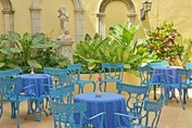 courtyard with blue chairs and tables