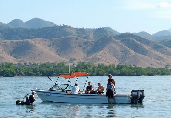fishing boat on the beach and mountains behind