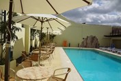 pool surrounded by sun loungers and umbrellas